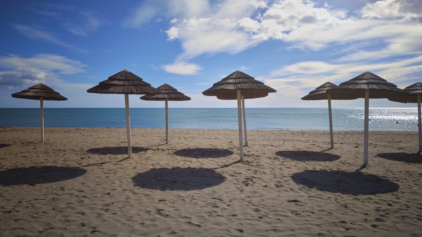 Mediterranean beach with straw parasols